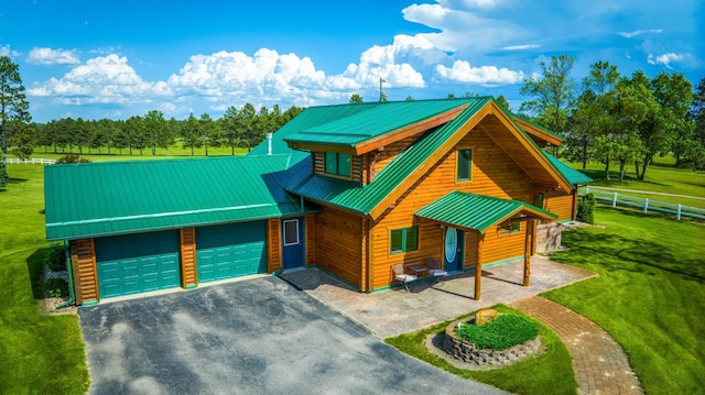 view of front of property featuring a garage and a front lawn