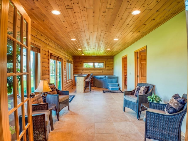 sitting room featuring log walls and wood ceiling