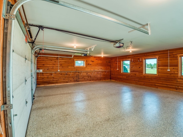 garage featuring wood walls and a garage door opener