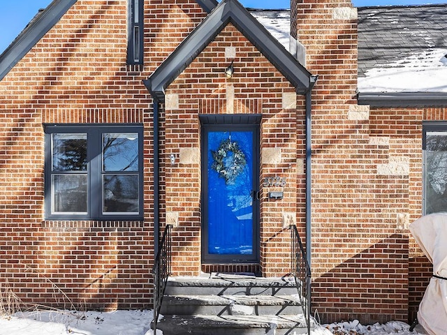 view of snow covered property entrance