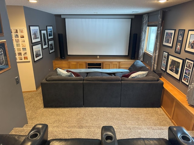 carpeted home theater room featuring a textured ceiling