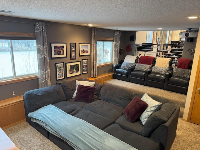 living room featuring a wealth of natural light, light carpet, and a textured ceiling