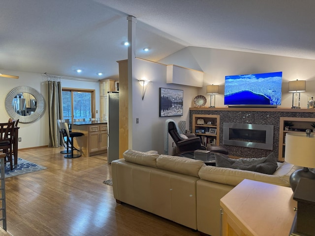 living room with light hardwood / wood-style flooring and lofted ceiling