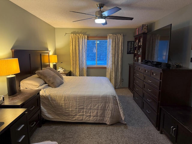 carpeted bedroom featuring a textured ceiling and ceiling fan