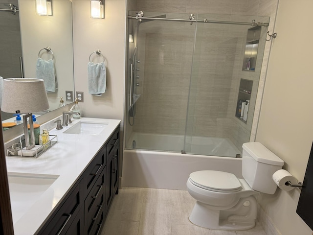 full bathroom with shower / bath combination with glass door, vanity, and toilet