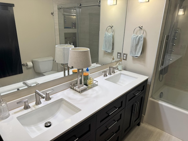 full bathroom with vanity, toilet, and shower / bath combination with glass door