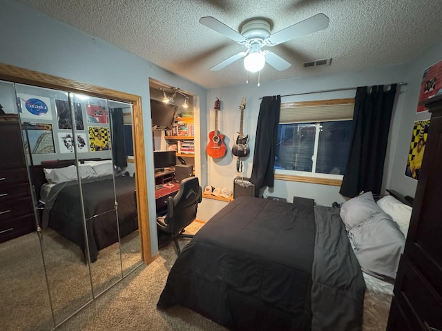 bedroom featuring carpet, a textured ceiling, and ceiling fan