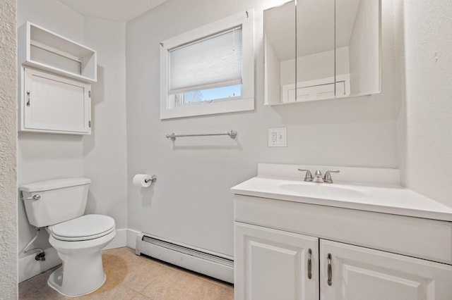 bathroom featuring tile patterned flooring, vanity, toilet, and a baseboard heating unit