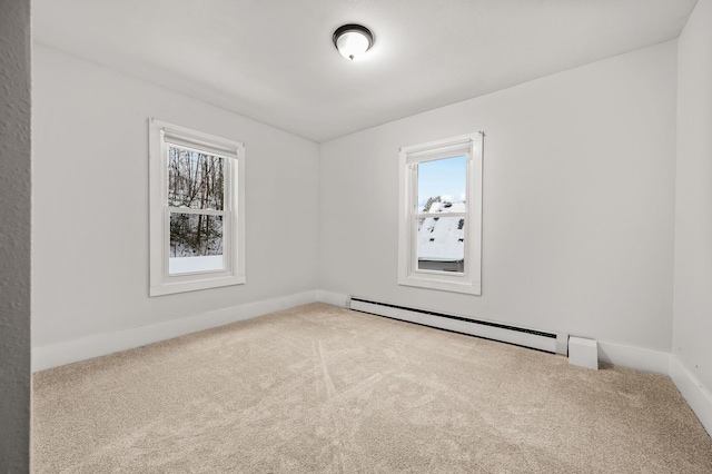 empty room with carpet floors and baseboard heating