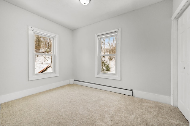 spare room with carpet flooring and baseboard heating