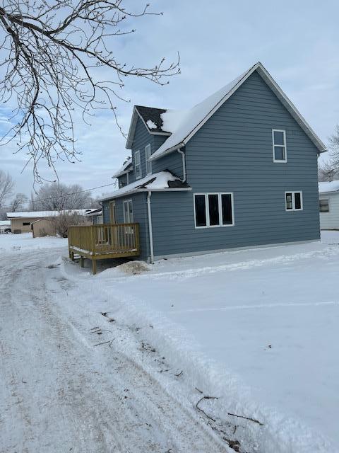 view of snowy exterior featuring a deck