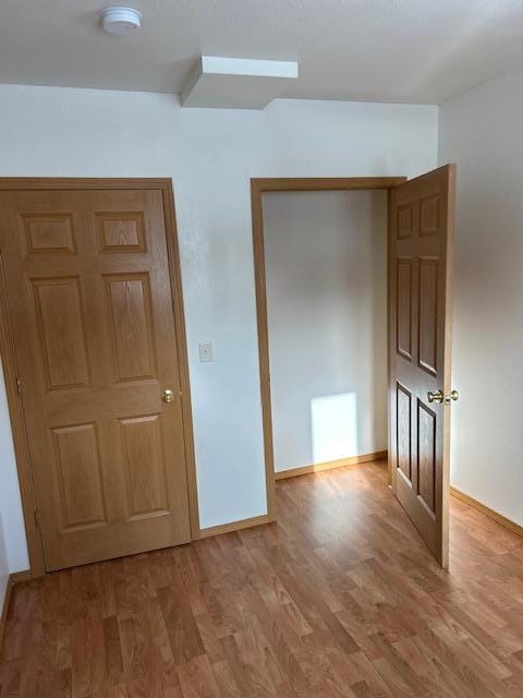 unfurnished bedroom featuring hardwood / wood-style floors