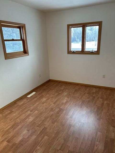 empty room featuring hardwood / wood-style flooring