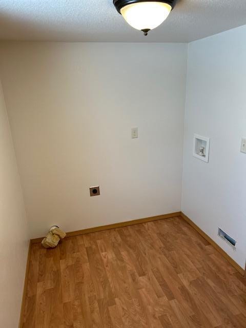 laundry area with electric dryer hookup, wood-type flooring, and hookup for a washing machine