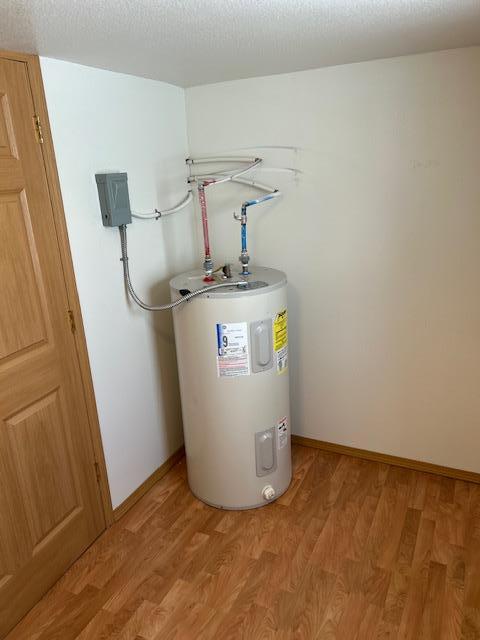 utility room featuring water heater