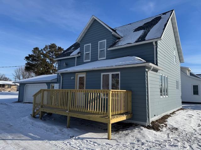 view of snow covered rear of property