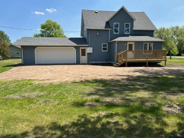 207 4th Ave E, Gary, MN 56545 - rear view of property featuring a deck, a garage, a lawn, and driveway