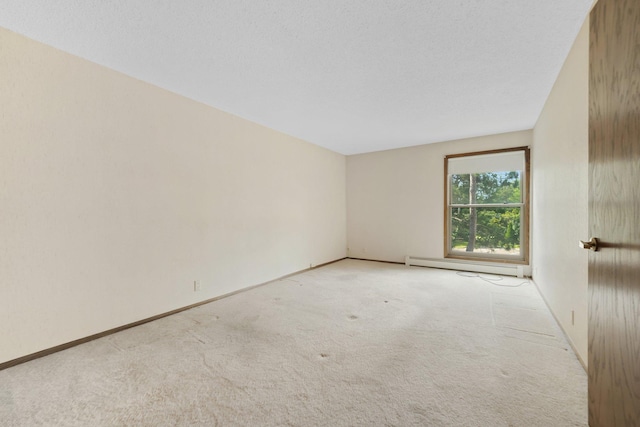 empty room with light colored carpet and a baseboard heating unit