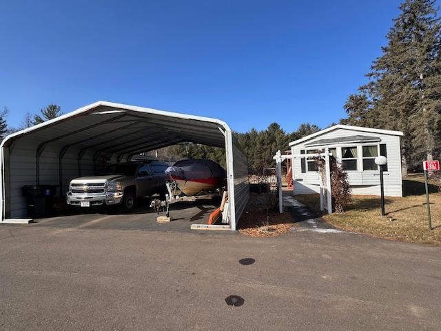 view of parking / parking lot with a carport