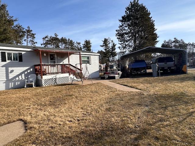 view of front of property with a front lawn and a carport