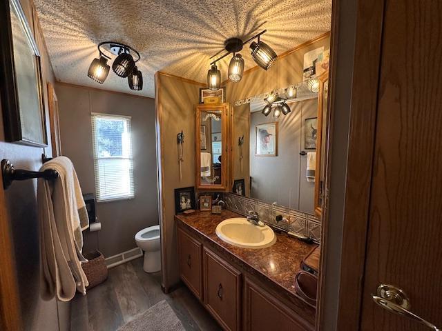 bathroom with wood-type flooring, vanity, and toilet