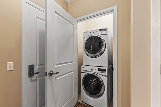 laundry area with stacked washing maching and dryer