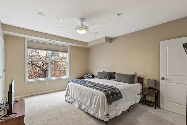 carpeted bedroom featuring a textured ceiling and ceiling fan