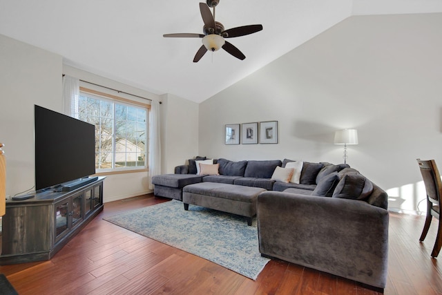 living room featuring dark wood-type flooring, high vaulted ceiling, and ceiling fan