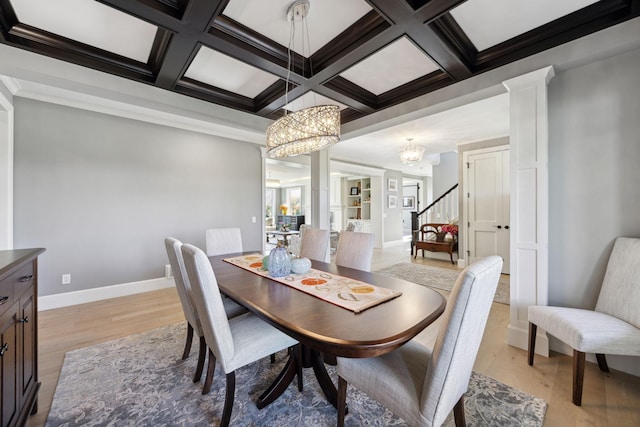 3175 Tuckborough Trl, Medina, MN 55356 - dining space featuring light wood-style floors, a chandelier, coffered ceiling, stairway, and beam ceiling