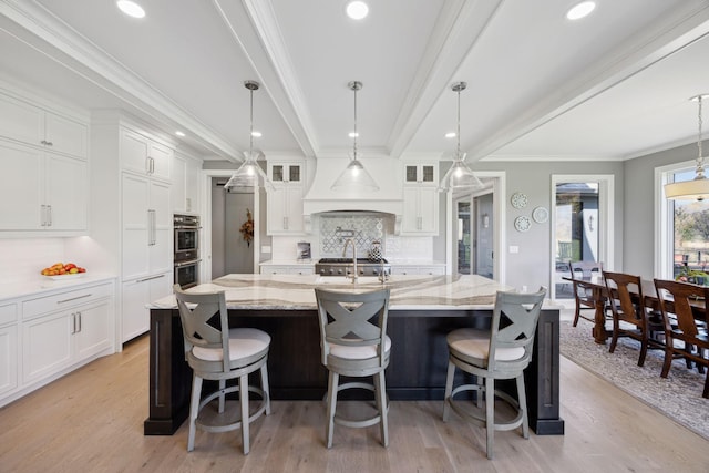 3175 Tuckborough Trl, Medina, MN 55356 - kitchen featuring backsplash, white cabinets, light wood-style floors, and recessed lighting