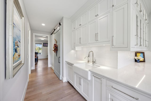 3175 Tuckborough Trl, Medina, MN 55356 - corridor featuring a barn door, light wood-type flooring, and recessed lighting