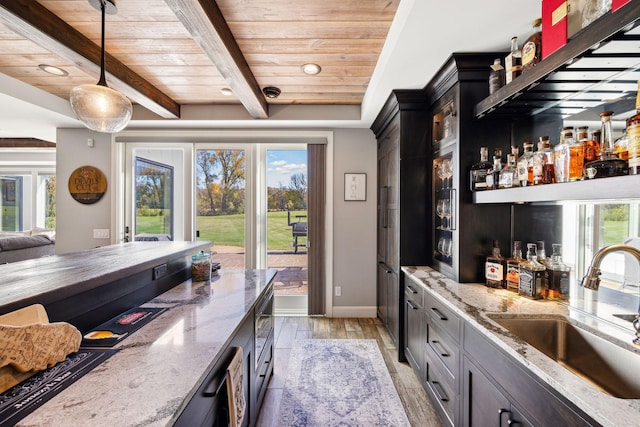 3175 Tuckborough Trl, Medina, MN 55356 - indoor wet bar with a wooden ceiling with exposed beams, healthy amount of natural light, pendant lighting, light wood-style flooring, and recessed lighting