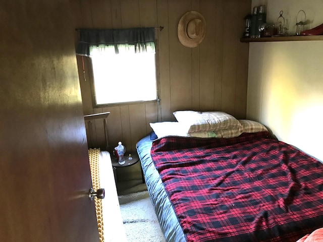 bedroom featuring wood walls