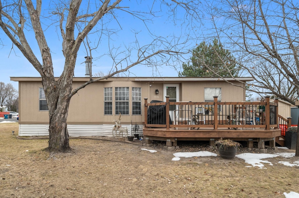 rear view of house featuring a wooden deck