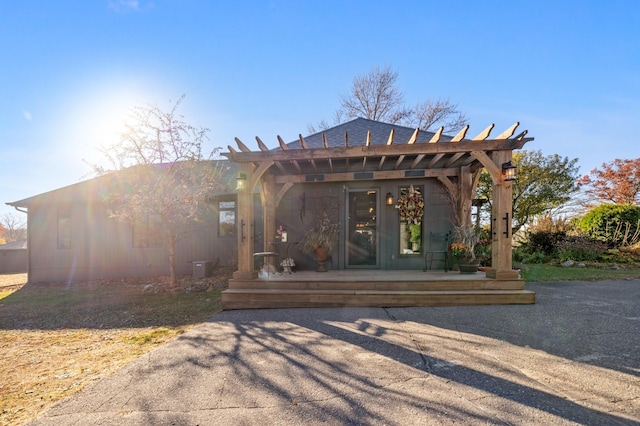 rear view of property with a pergola and a patio