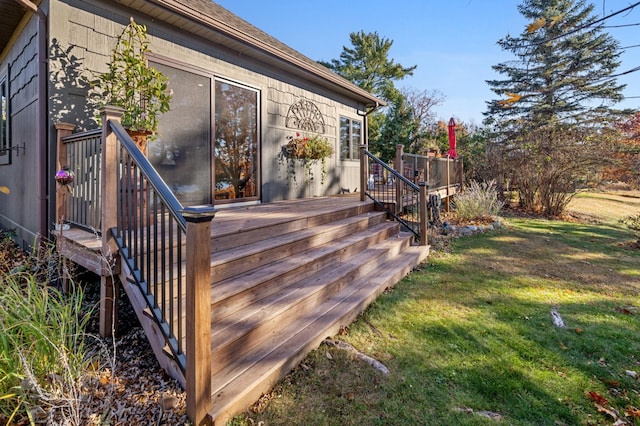 wooden terrace featuring a lawn