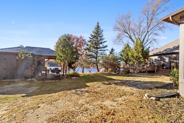 view of yard featuring a deck with water view