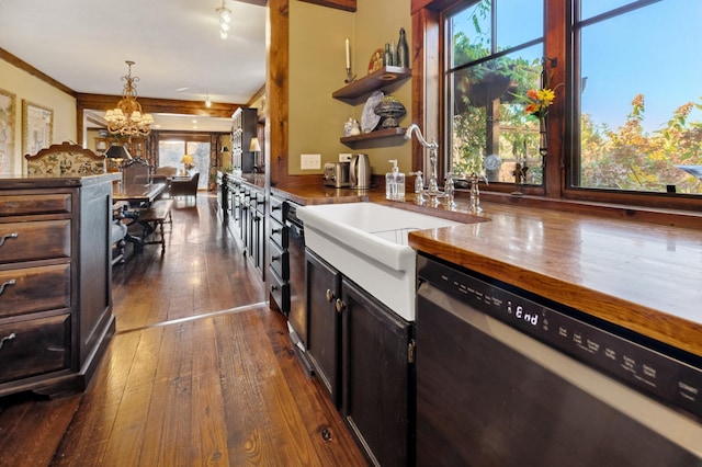 kitchen with a wealth of natural light, sink, an inviting chandelier, dishwasher, and hanging light fixtures