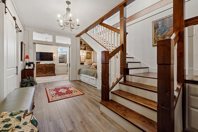 stairway with an inviting chandelier and hardwood / wood-style flooring