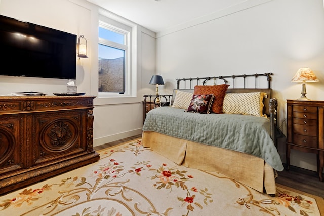 bedroom featuring crown molding and light hardwood / wood-style floors