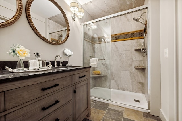 bathroom with a shower with door and vanity