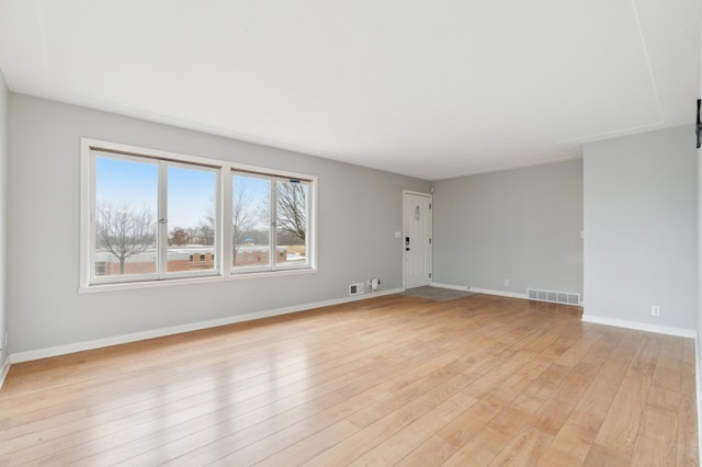 unfurnished room with light hardwood / wood-style flooring