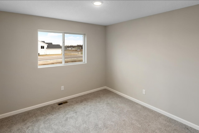 unfurnished room featuring carpet