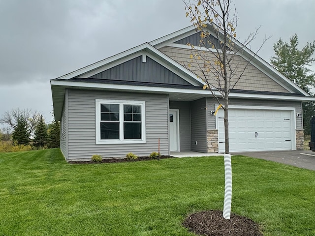 view of front of home with a front lawn and a garage