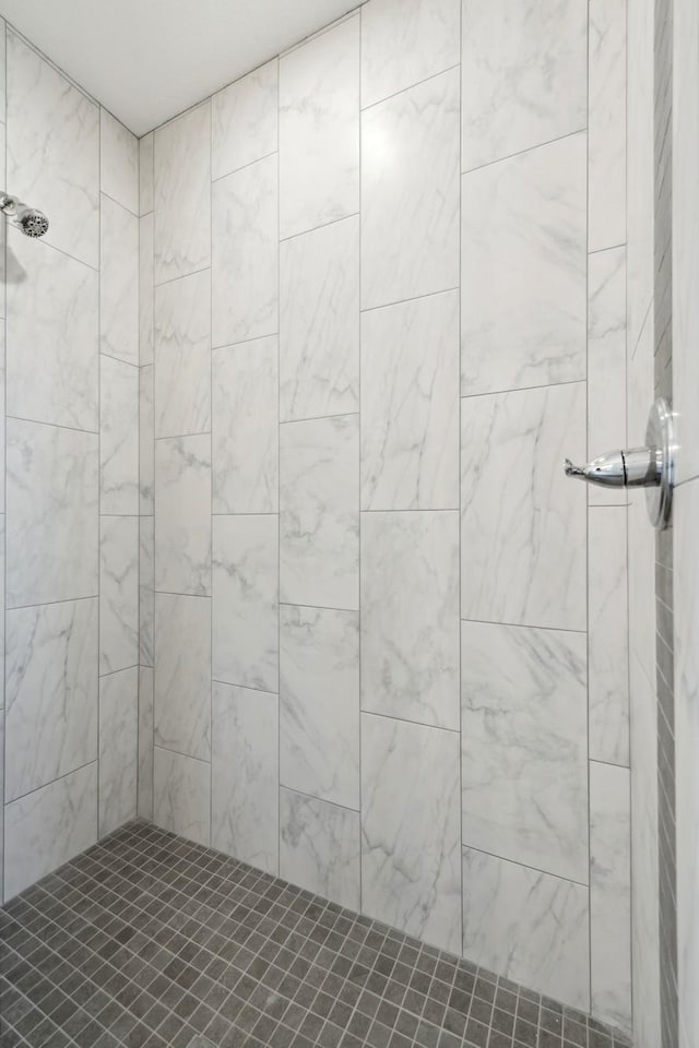 bathroom with a tile shower