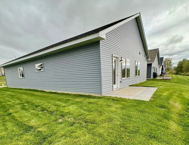 view of home's exterior featuring a lawn and a patio area