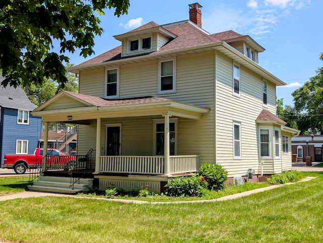 410 5th St, Montevideo, MN 56265 - traditional style home with a porch, a chimney, roof with shingles, and a front lawn
