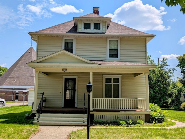 410 5th St, Montevideo, MN 56265 - american foursquare style home with a porch, a shingled roof, and a chimney