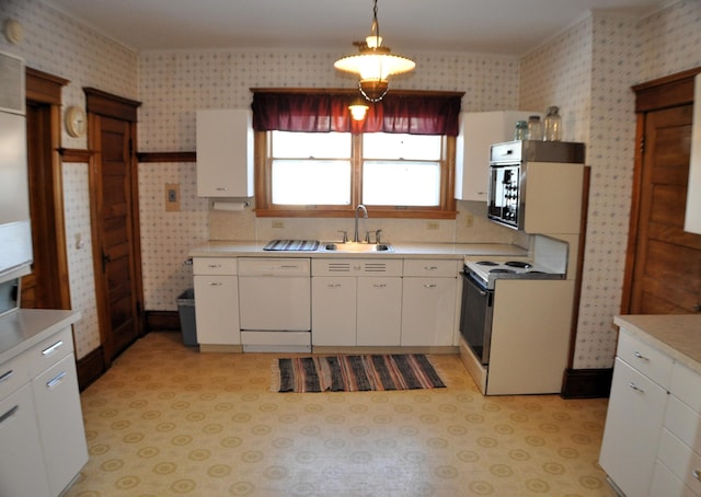 410 5th St, Montevideo, MN 56265 - kitchen featuring white appliances, wallpapered walls, light countertops, white cabinets, and hanging light fixtures