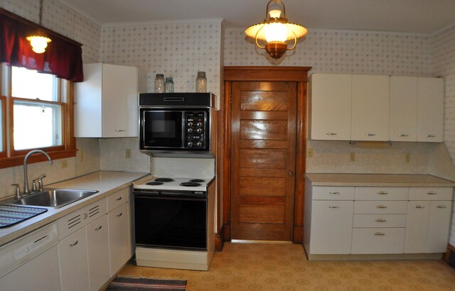 410 5th St, Montevideo, MN 56265 - kitchen with white appliances, wallpapered walls, ornamental molding, light countertops, and white cabinets